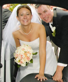 Bride and groom getting into their limo